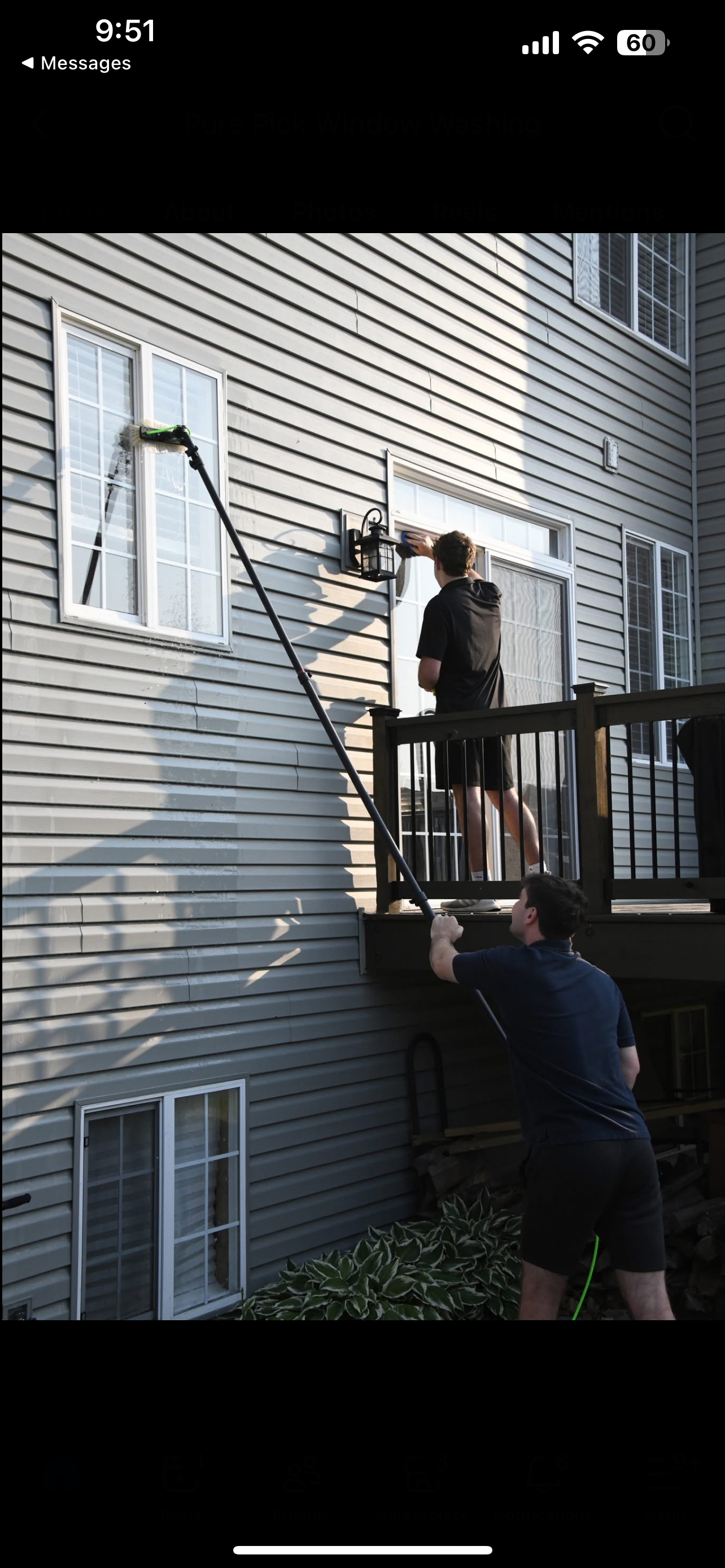 Pure Pick team cleaning windows on two-story home